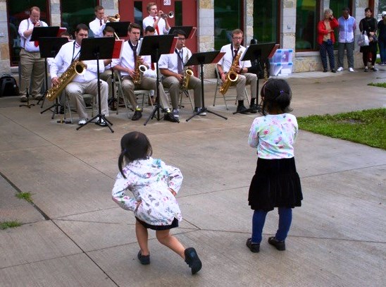 Kids dancing at a community band concert